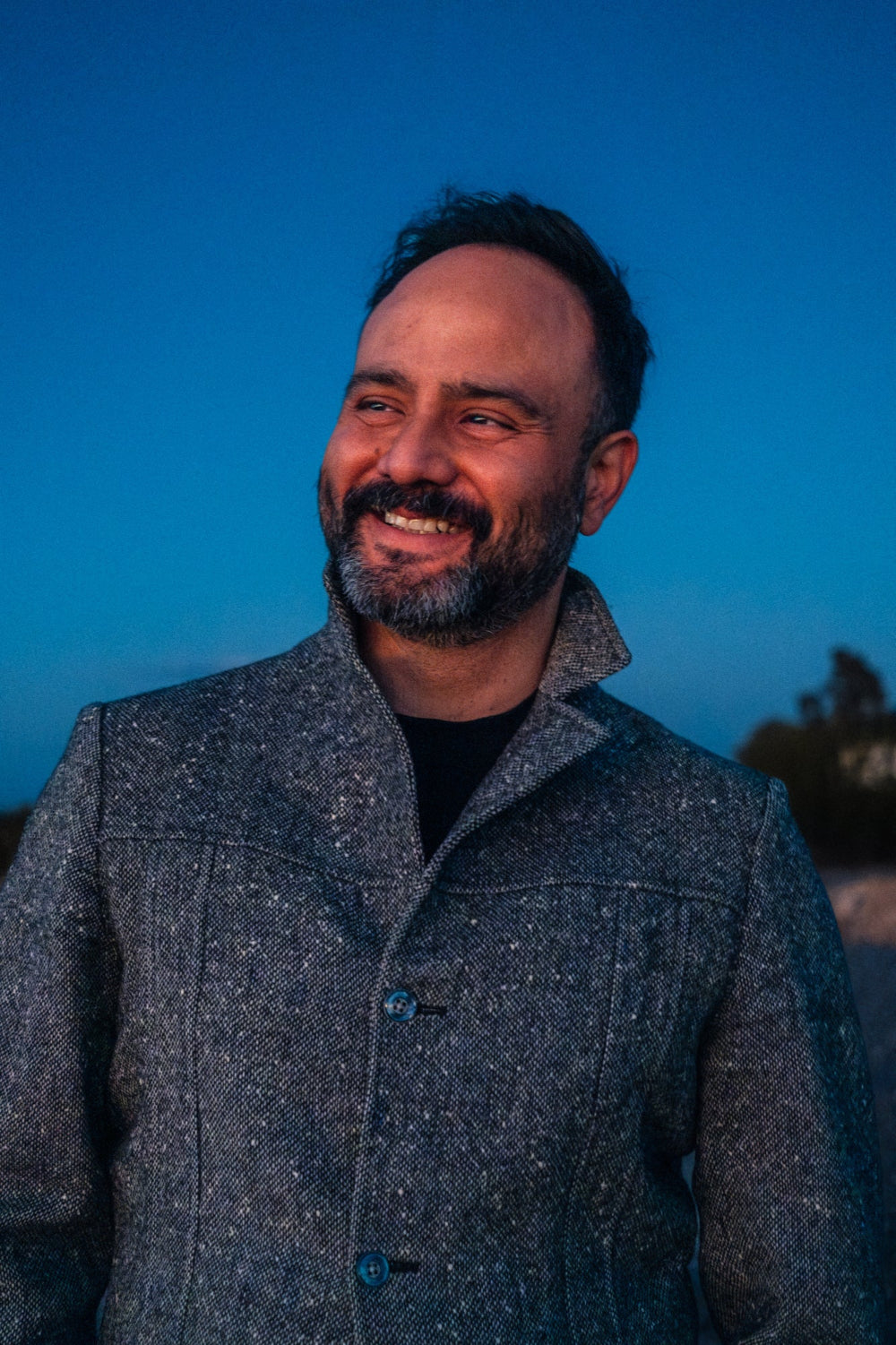 Matt found of Elemental deodorant wearing a gray coat against a blue sky