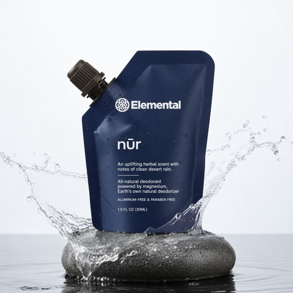 Elemental NUR refillable deodorant pouch on a stone with water splash